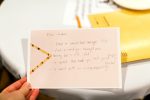 A note card with handwritten questions and answers.